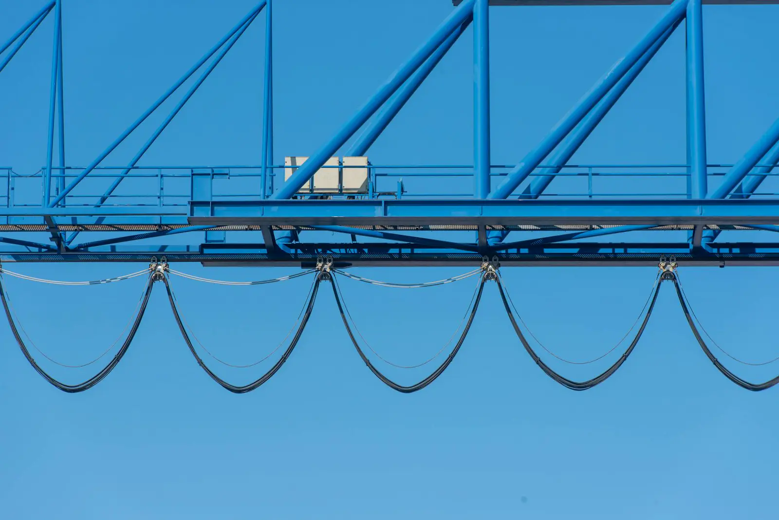 Cranes lifting stadium roof trusses